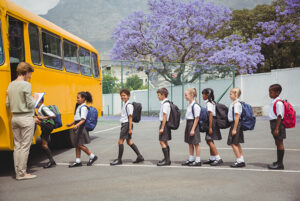school children getting on a bus