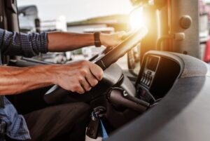 Truck driver hands on steering wheel