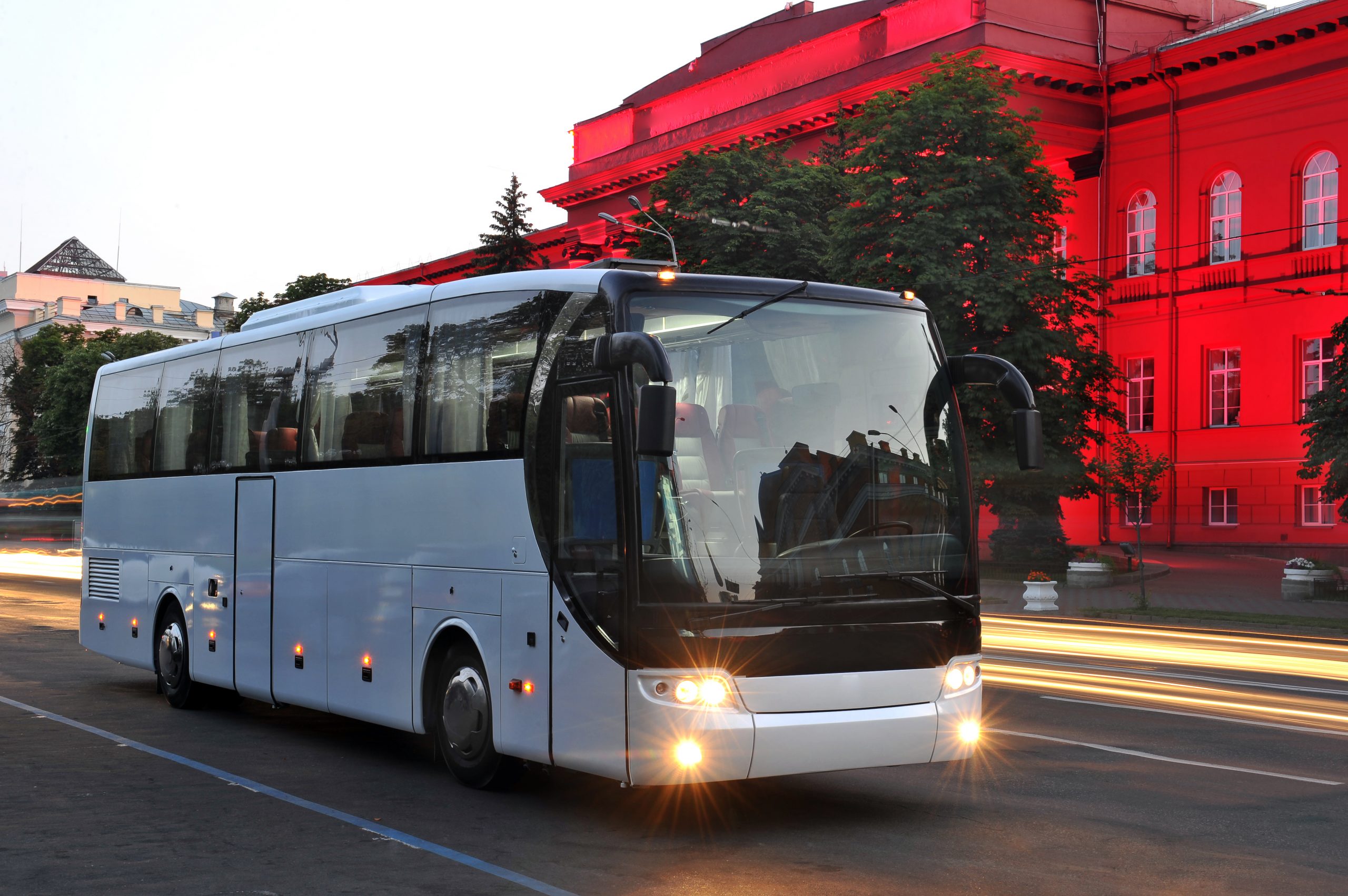 Coach in Europe with illuminated building