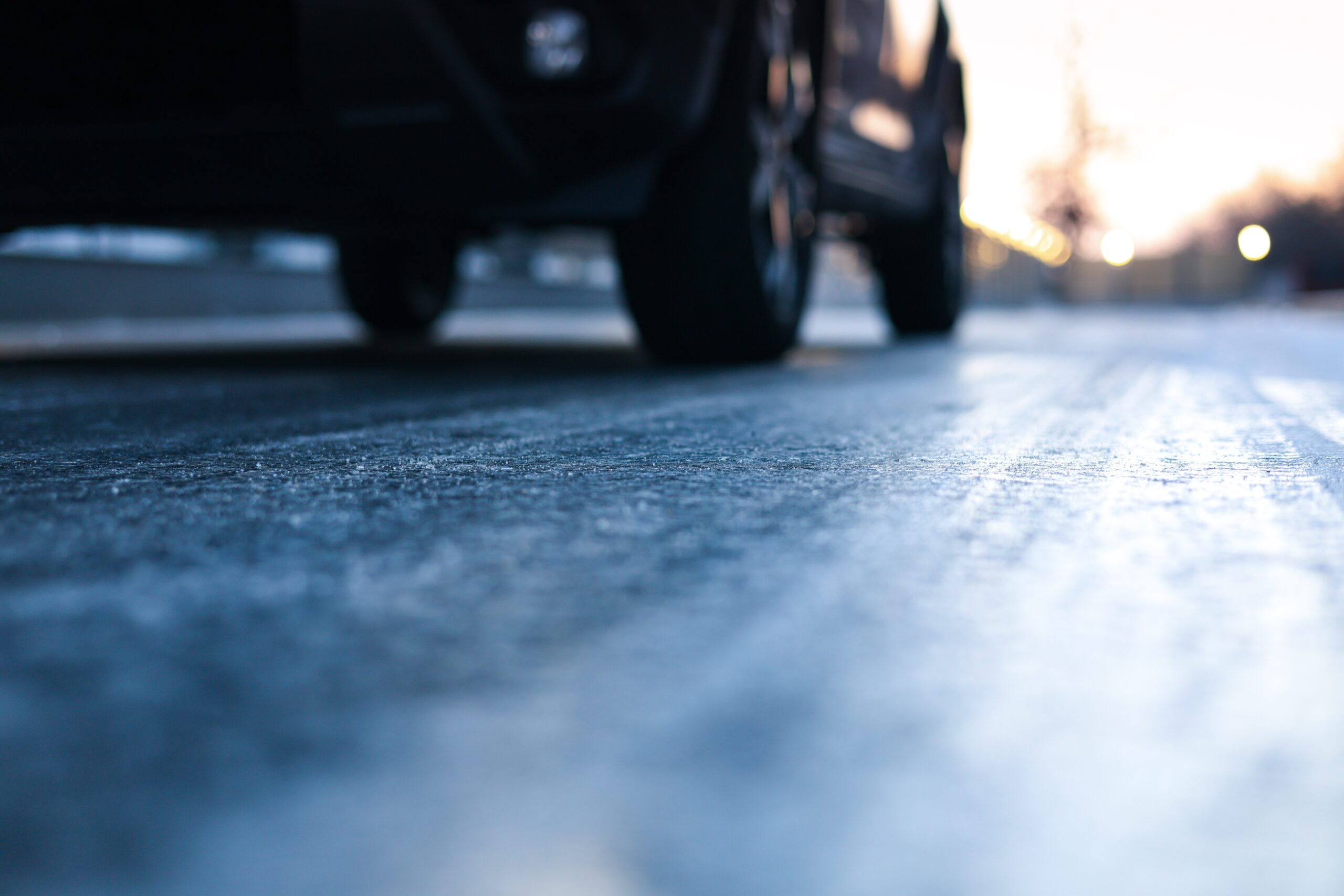 Close-up of car wheels on an icy road