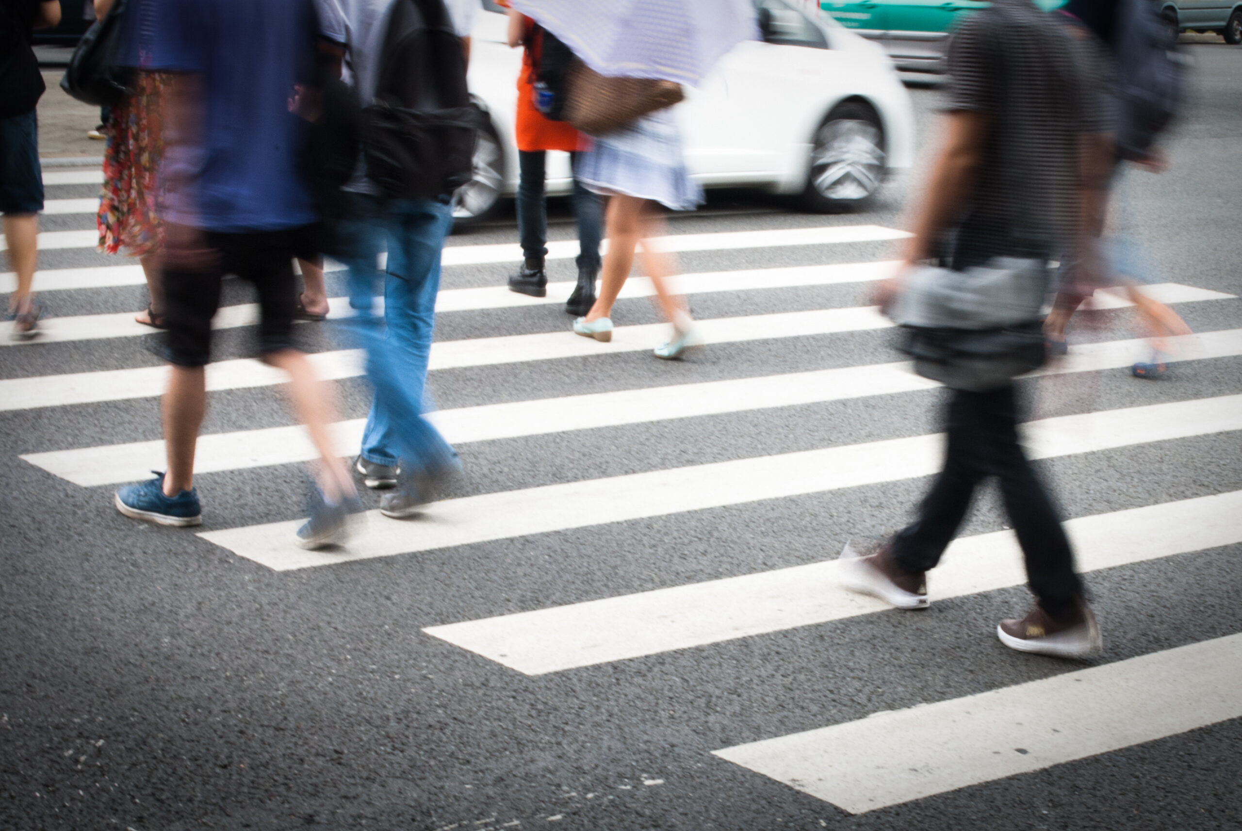 Pedestrian crossing at a busy intersection, representing road traffic accident liability and negligence considerations.