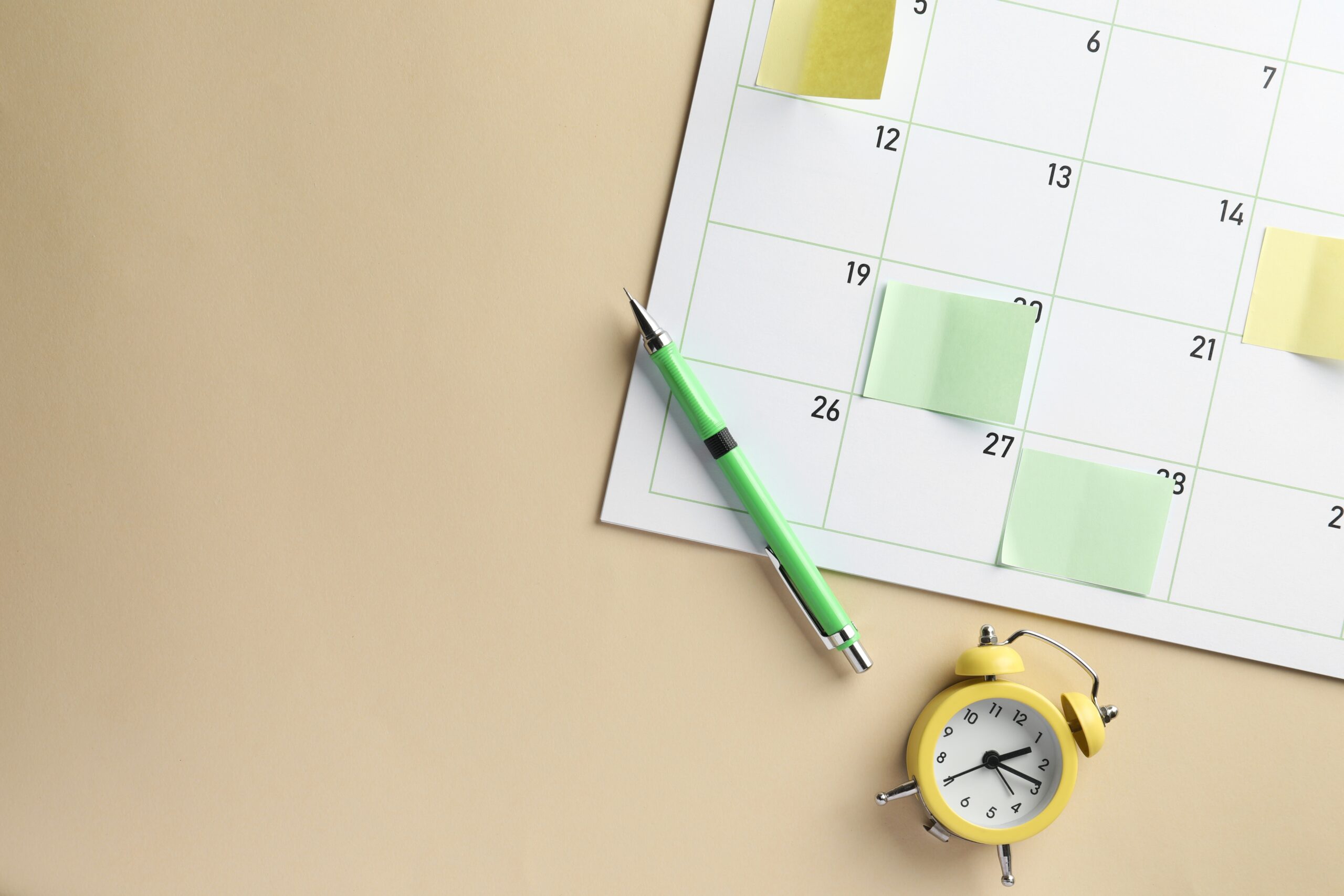 A close-up of a calendar with a pen resting on it, symbolizing holiday planning and statutory leave entitlement for 2025.