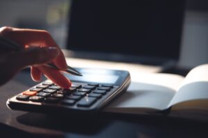 Calculator on a desk representing employment statutory rate increases and financial calculations.