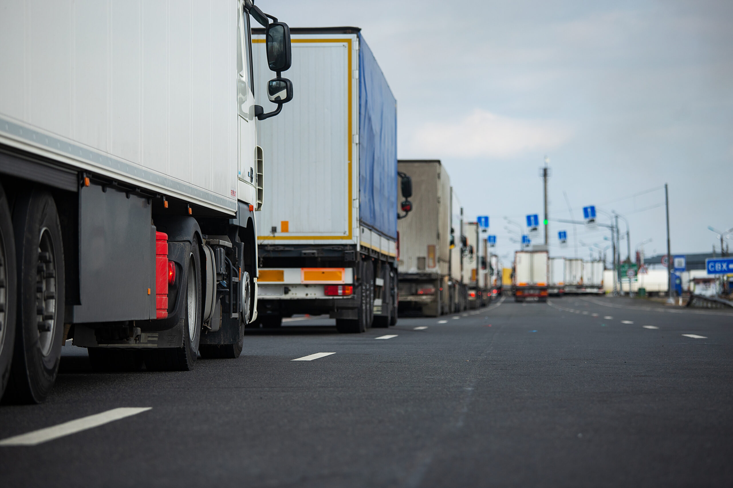 Trucks at a border checkpoint, symbolising border control and haulage industry.