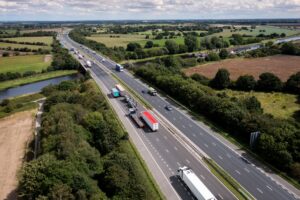 Aerial view of a busy UK motorway representing commercial vehicle operations and road safety compliance.