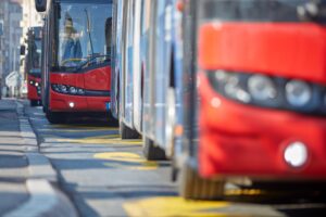Close-up view of buses lined up in a city street