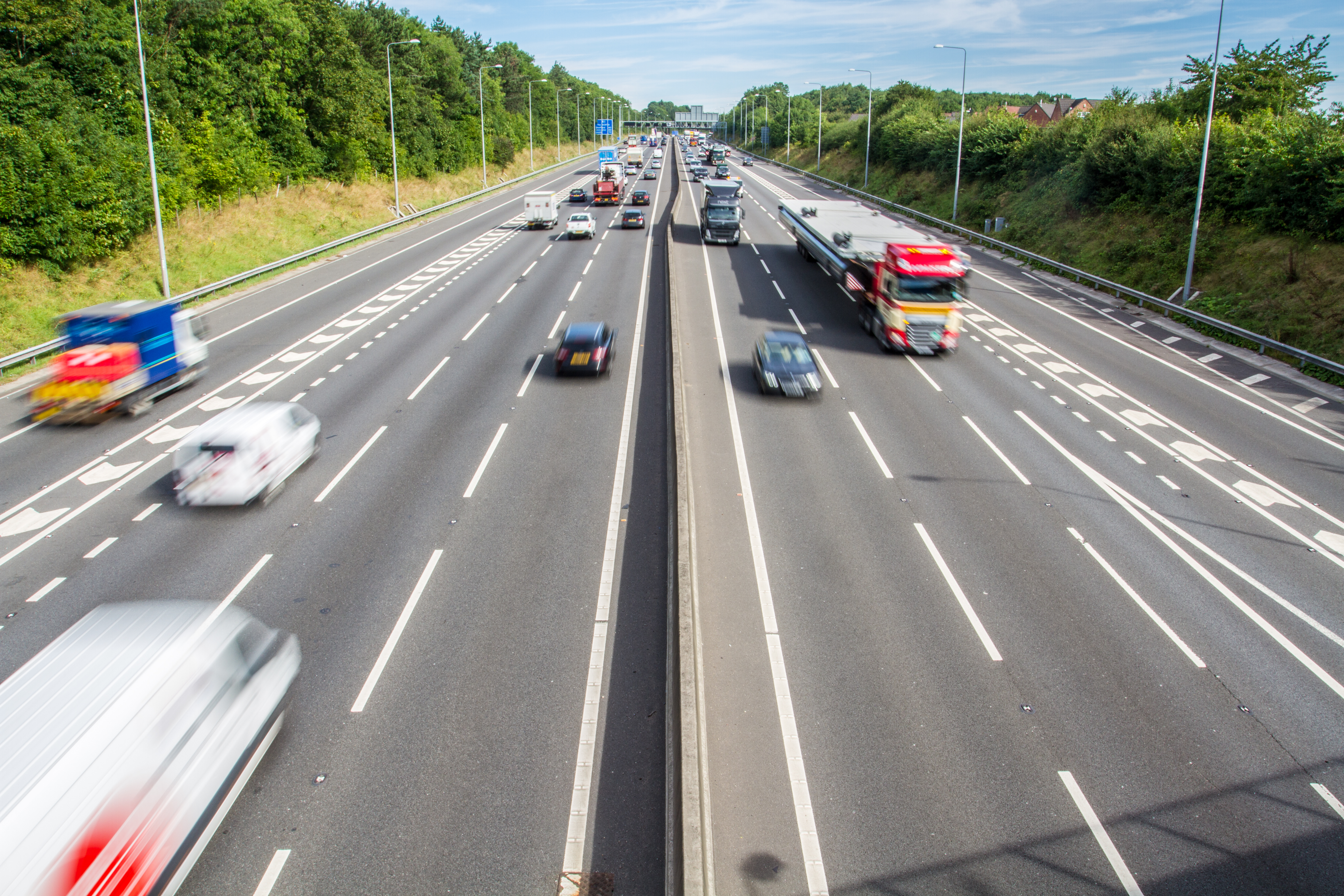 Photo of a busy motorway with multiple cars traveling, symbolisng vehicle operations and road transport compliance.
