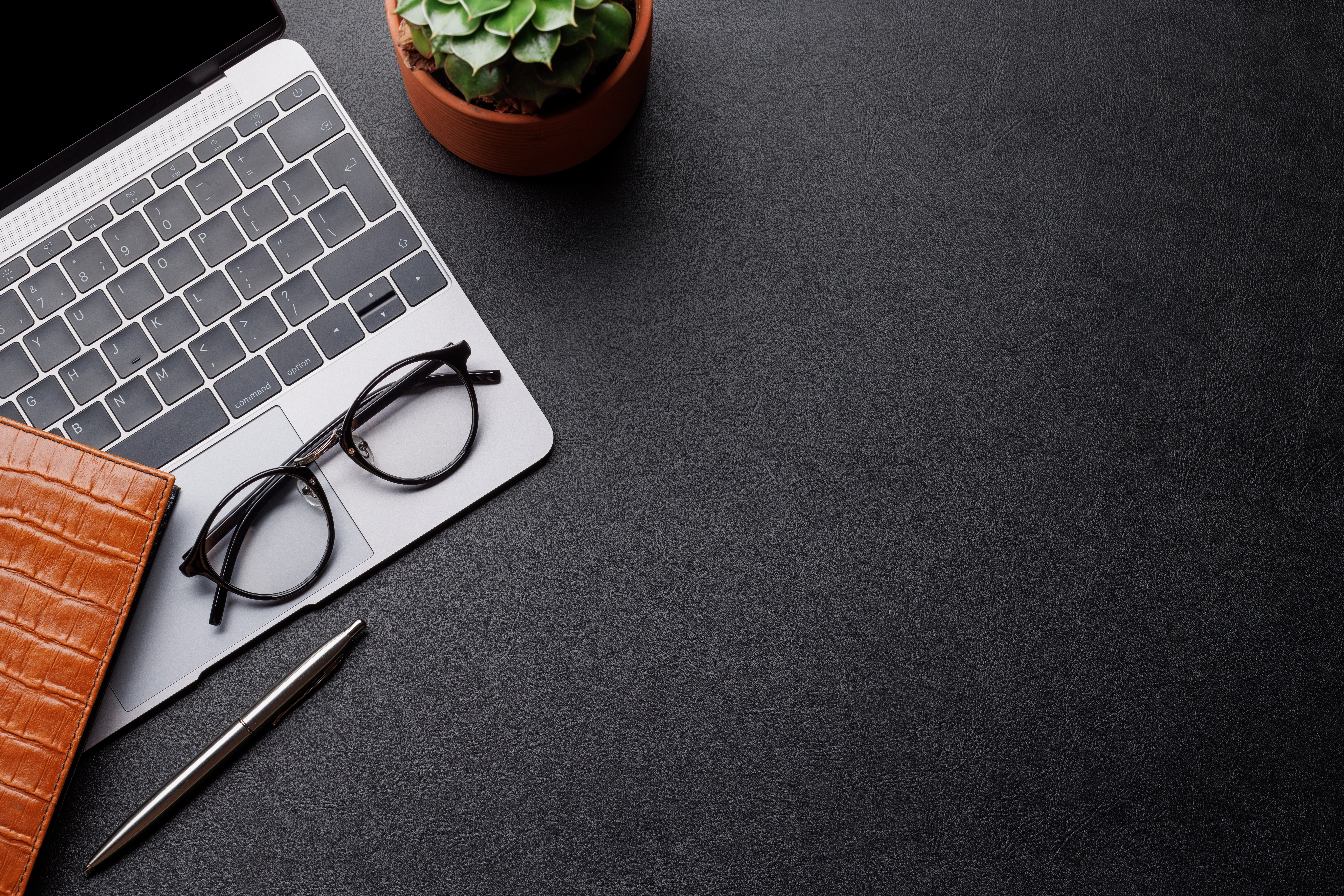 Desk with glasses and book representing constructive dismissal and employment law guidance.
