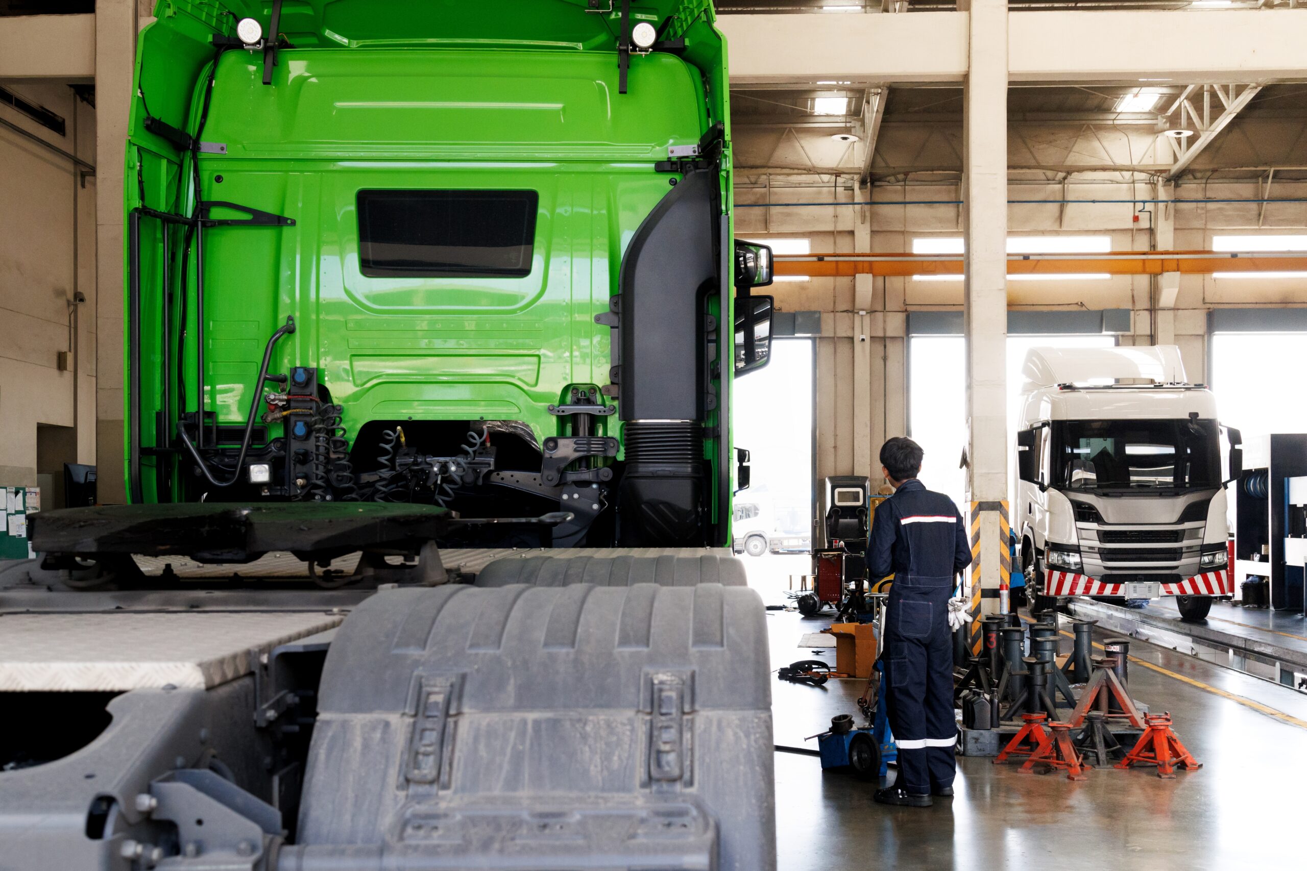 Transport professional inspecting a vehicle as part of HGV and PSV compliance checks.