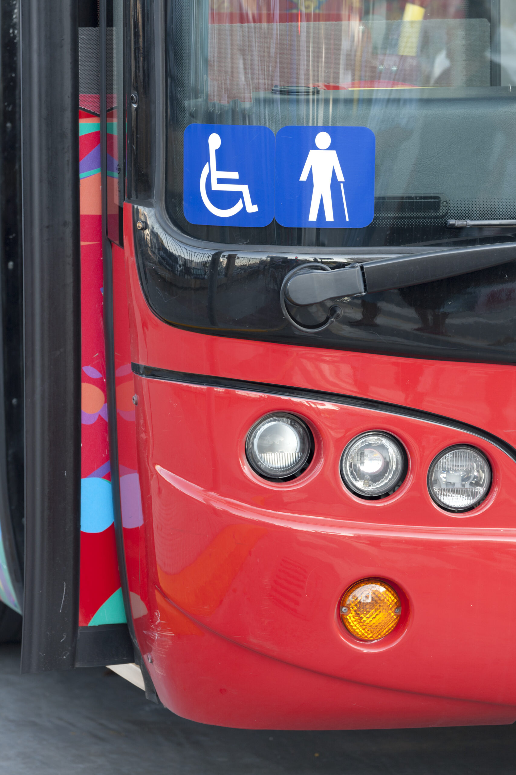 Front of a bus displaying a disabled access symbol.